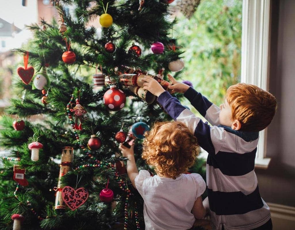 kids decorating christmas tree